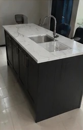 Navy kitchen island with white marble-effect worktop and sink